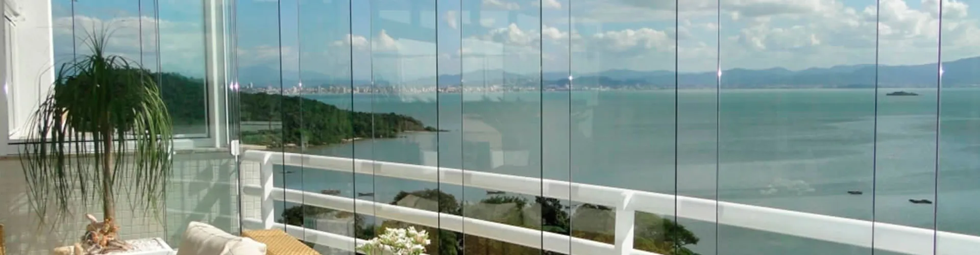Sacada envidraçada com vista para o mar, executada pela Vitrais Celso